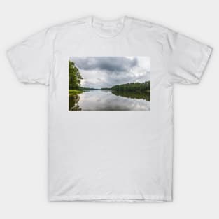 Cloudy sky over calm lake T-Shirt